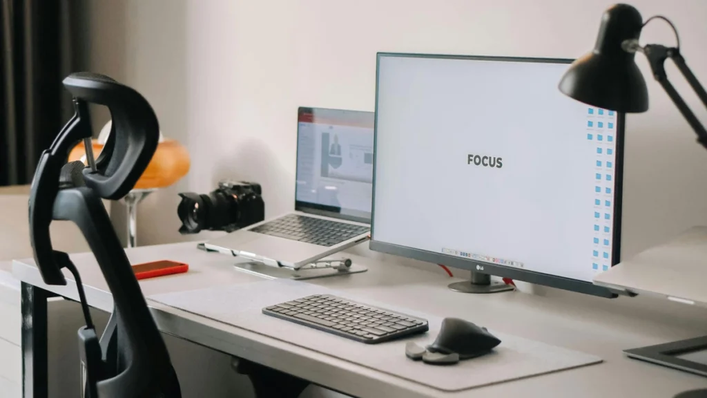 A desk featuring a computer, keyboard, and mouse arranged for work.